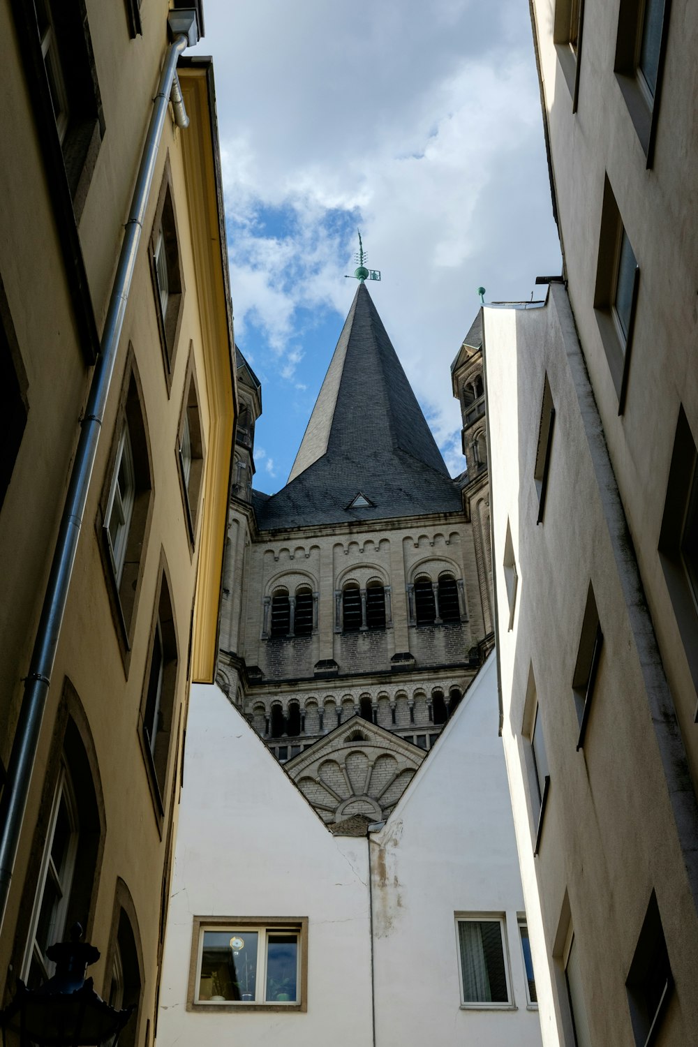 looking up at a tall building with a steeple