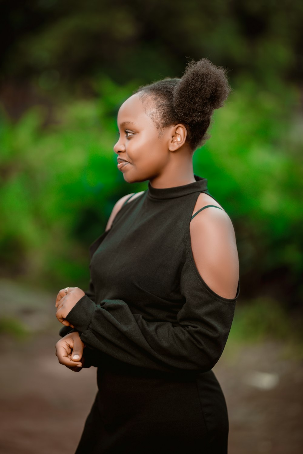 a woman in a black dress with her arms crossed