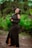 a woman in a black dress posing for a picture