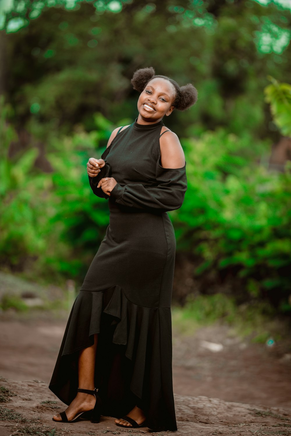 a woman in a black dress posing for a picture