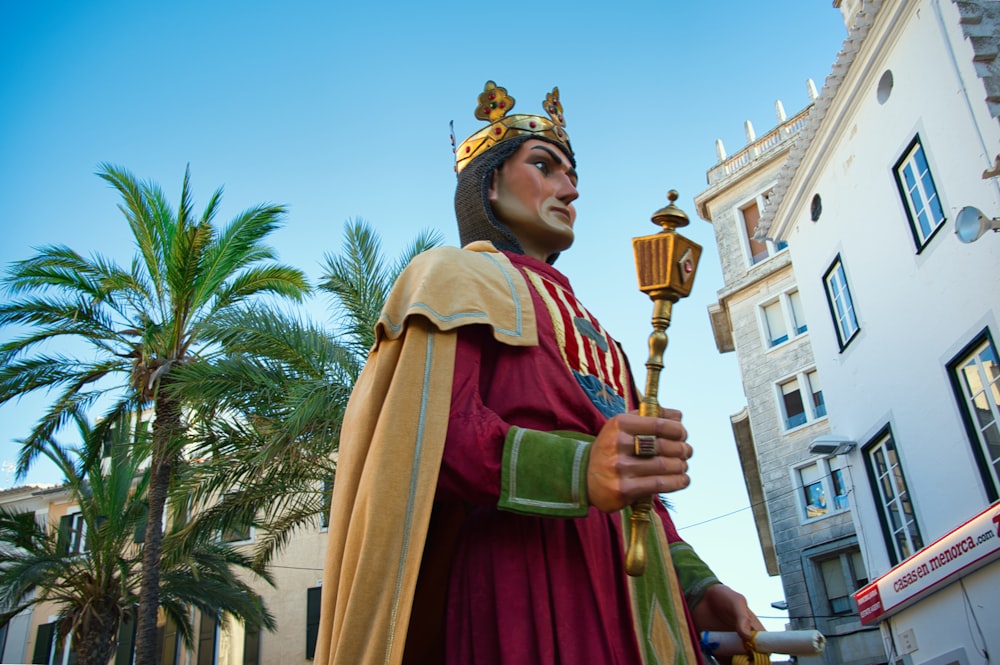 a statue of a king holding a staff