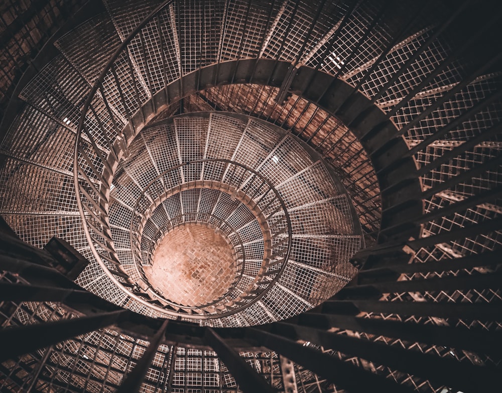 a spiral staircase in a building with a skylight