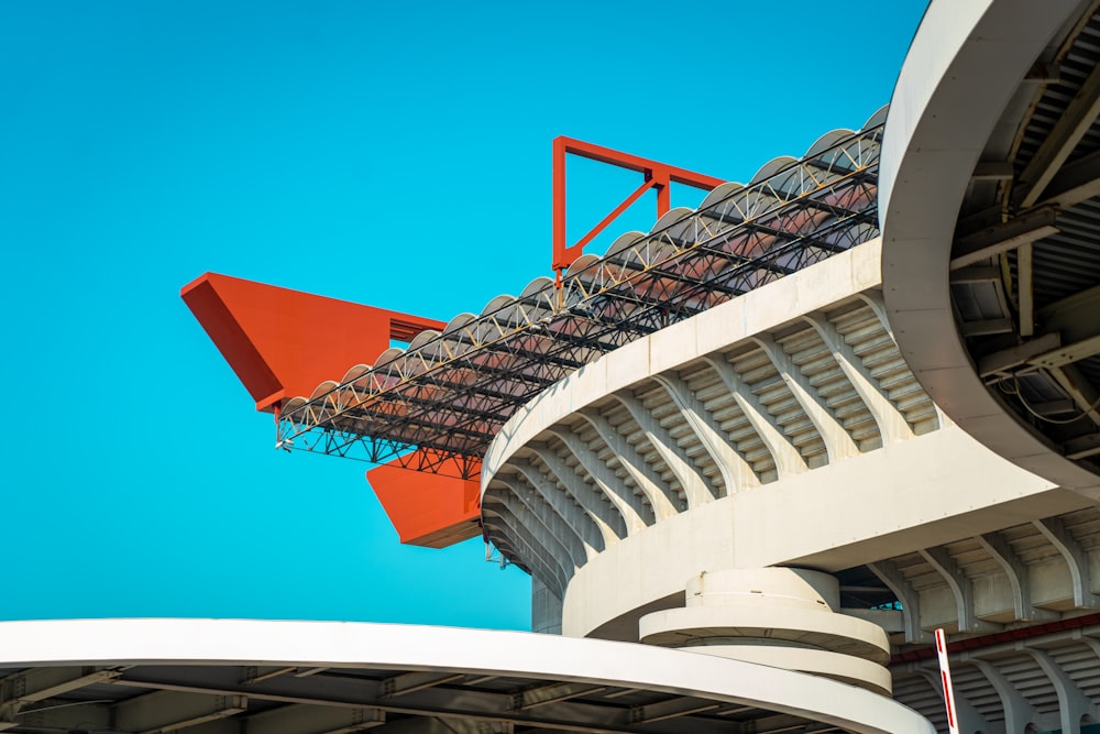 a red arrow on top of a white building