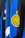 Close-up view of a sports jersey featuring bold vertical stripes in blue and black, adorned with a prominent yellow logo featuring a star on top. Additional elements include a Nike swoosh in yellow, a circular emblem with red, white, and green colors, and a section with black stars on white.