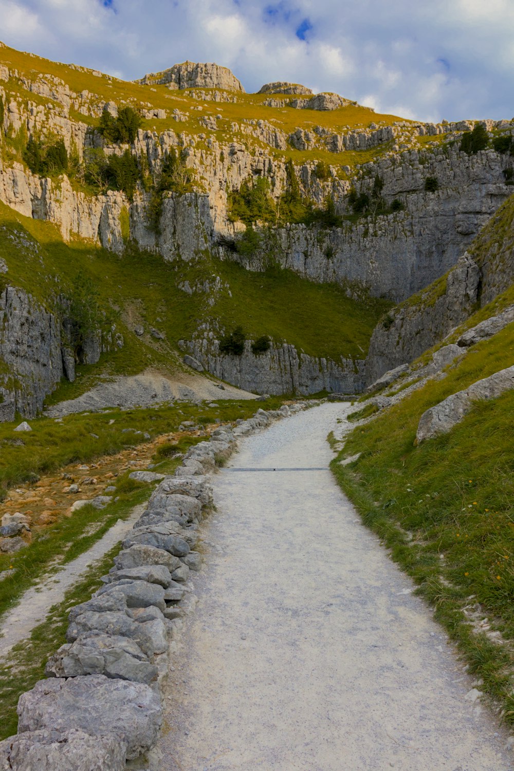 a stone path leading to a mountain side