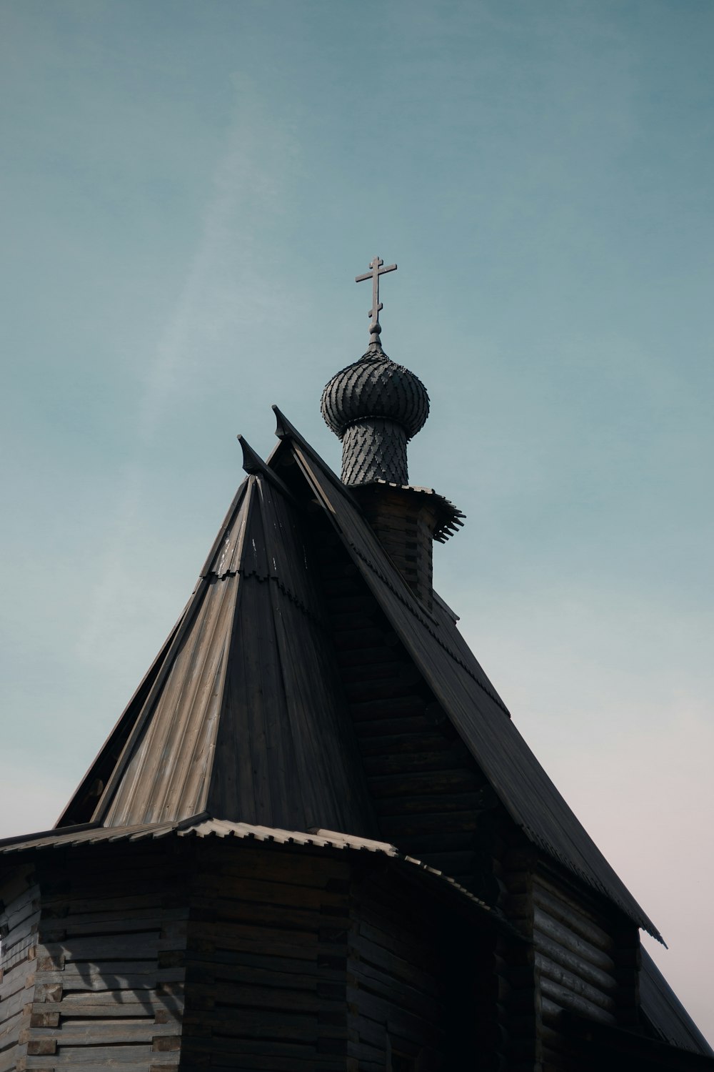 a church steeple with a cross on top