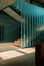 a living room with a couch and a stair case