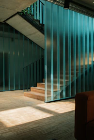 a living room with a couch and a stair case