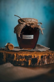 a jar of honey sitting on top of a wooden table