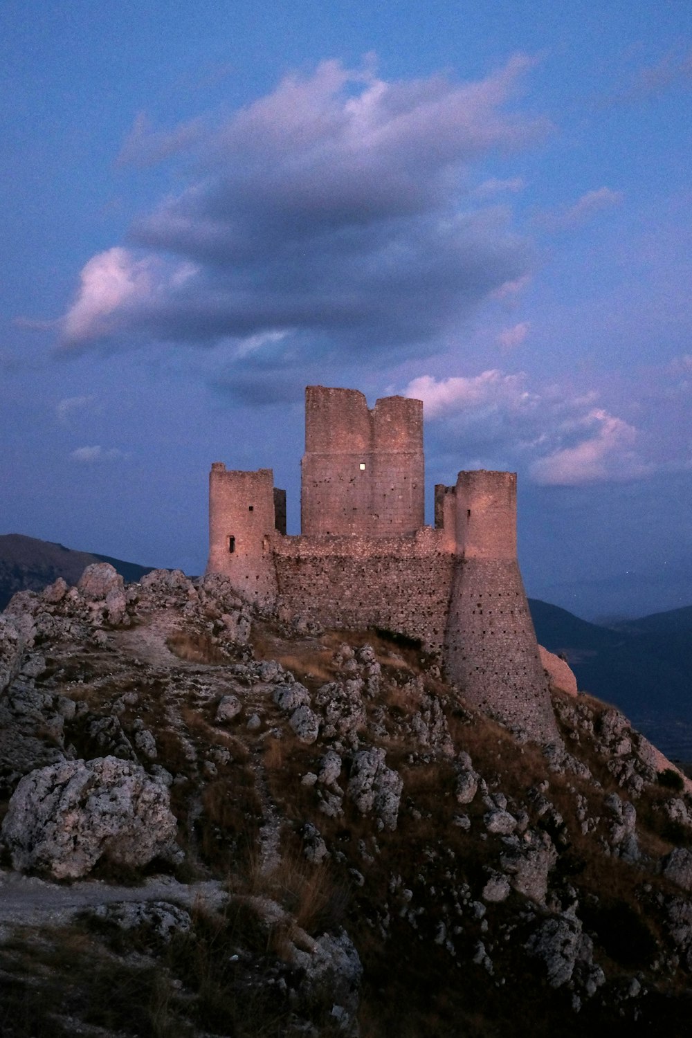 a castle sitting on top of a rocky hill