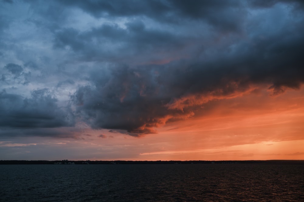 a large body of water under a cloudy sky