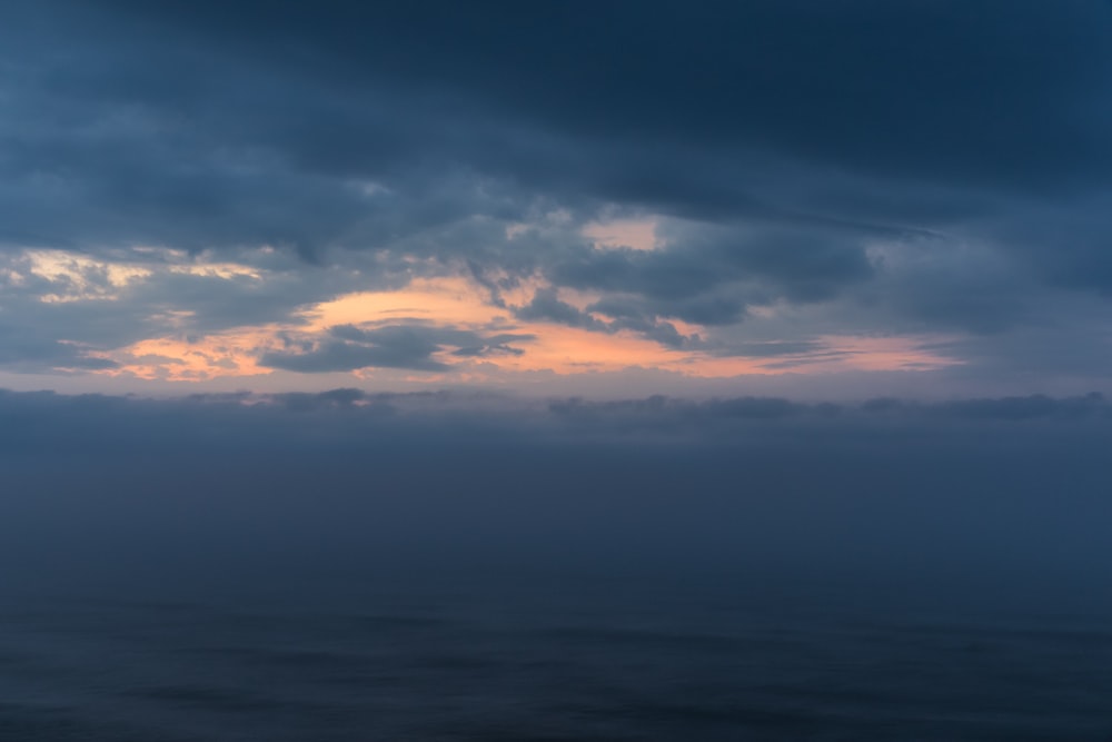 a large body of water under a cloudy sky