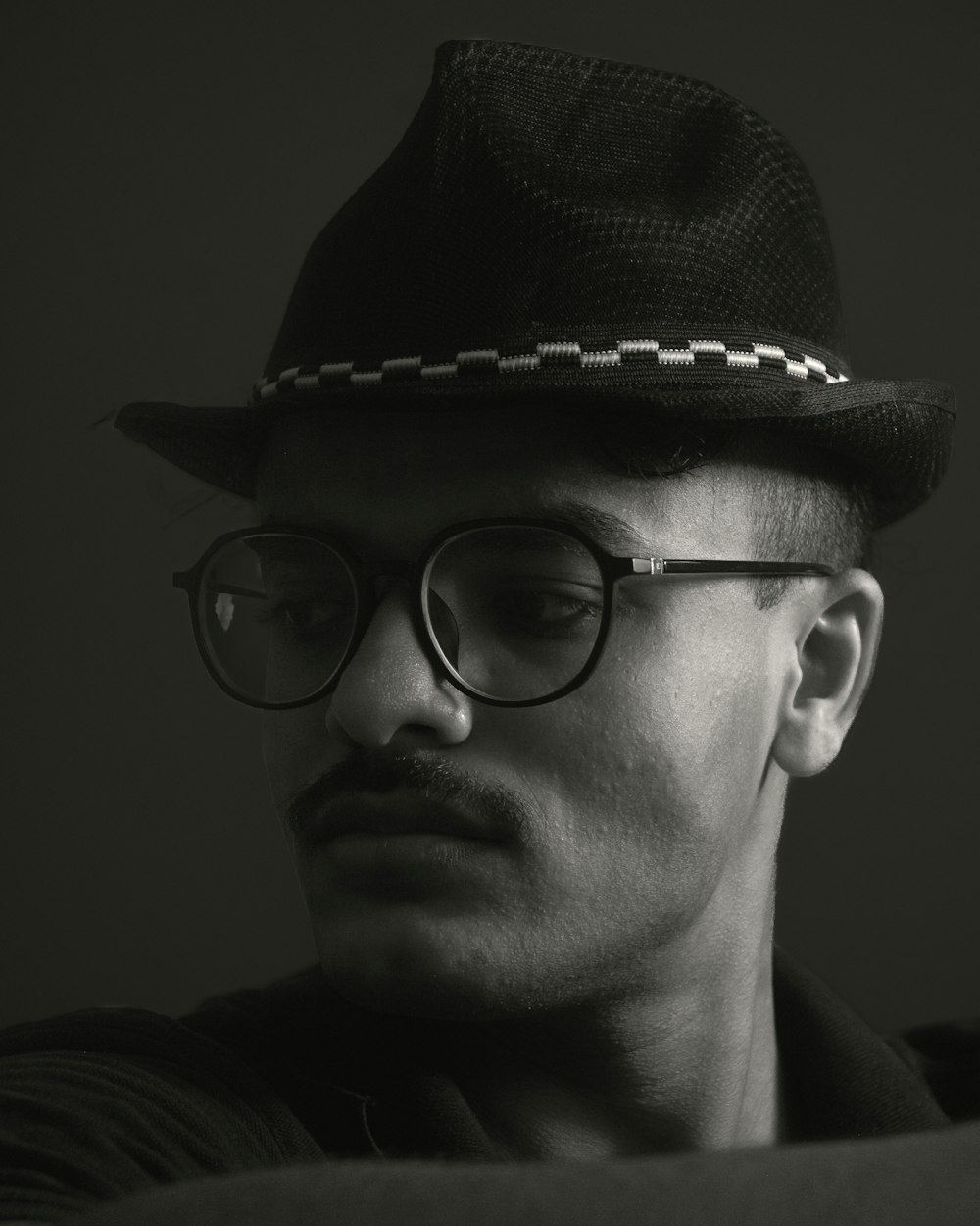 a man wearing glasses and a hat