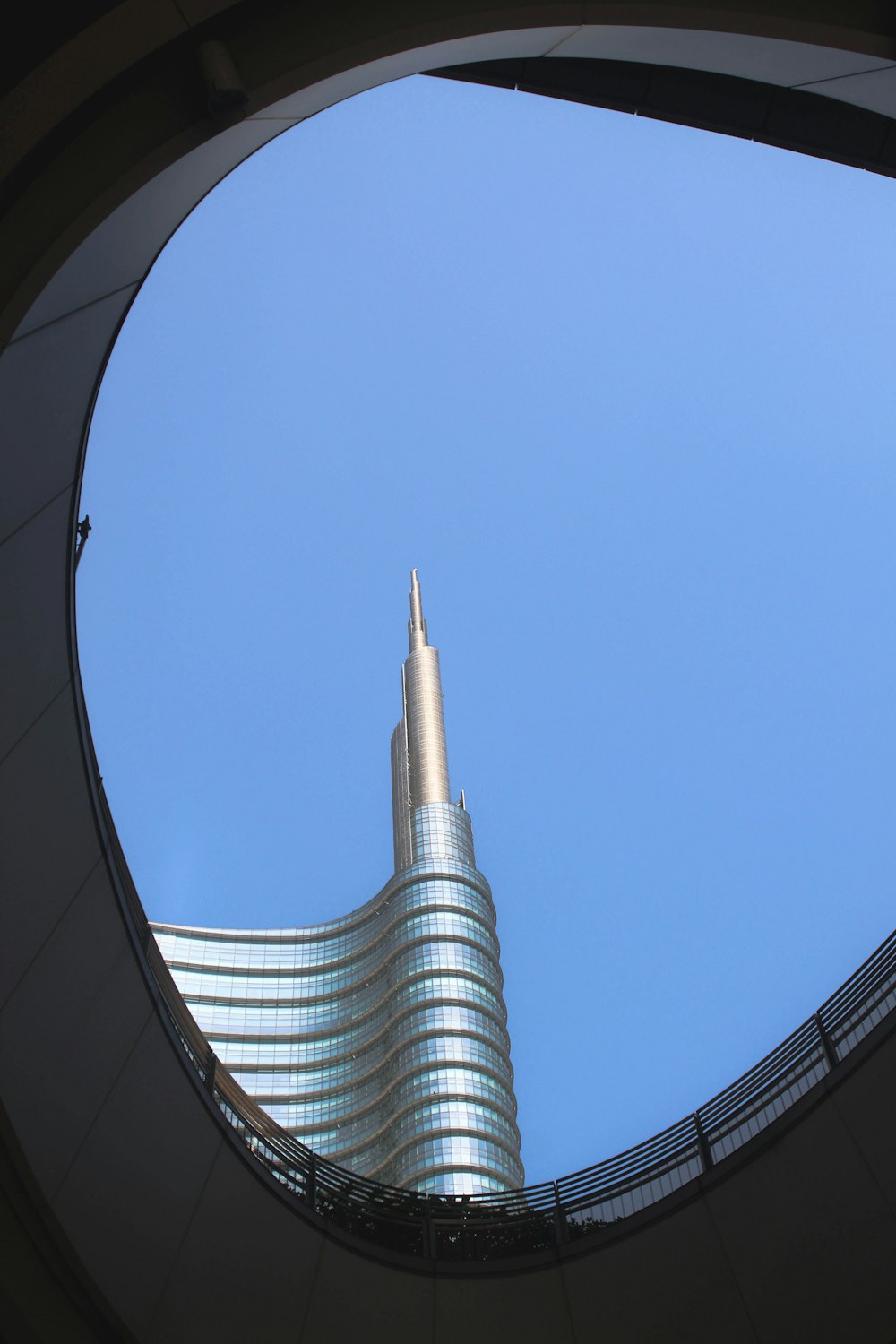 a view of a tall building through a circular window