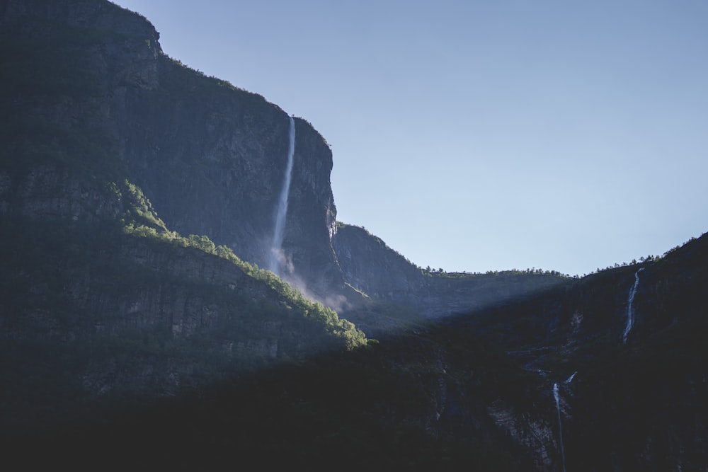 a mountain with a waterfall in the middle of it