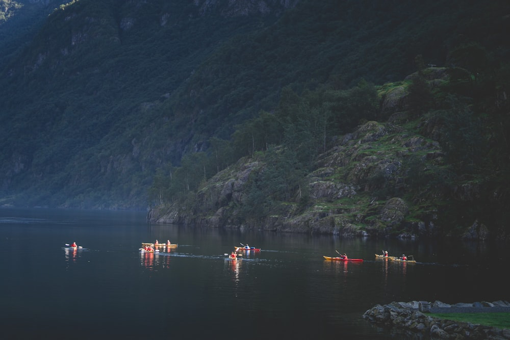 a group of people in canoes paddling on a lake