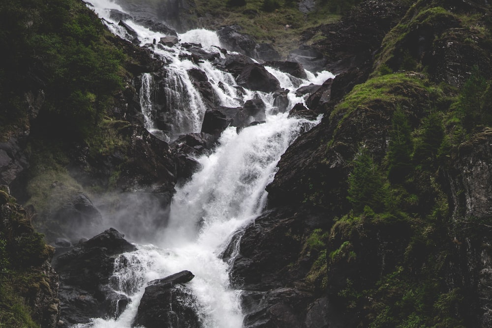 a waterfall with water cascading down the side of it