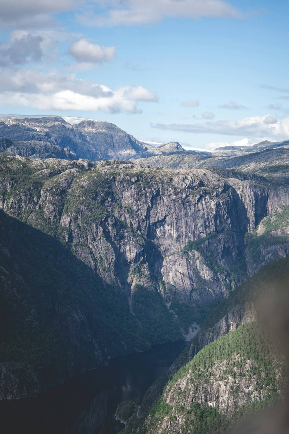 a scenic view of a mountain range with a valley in the foreground