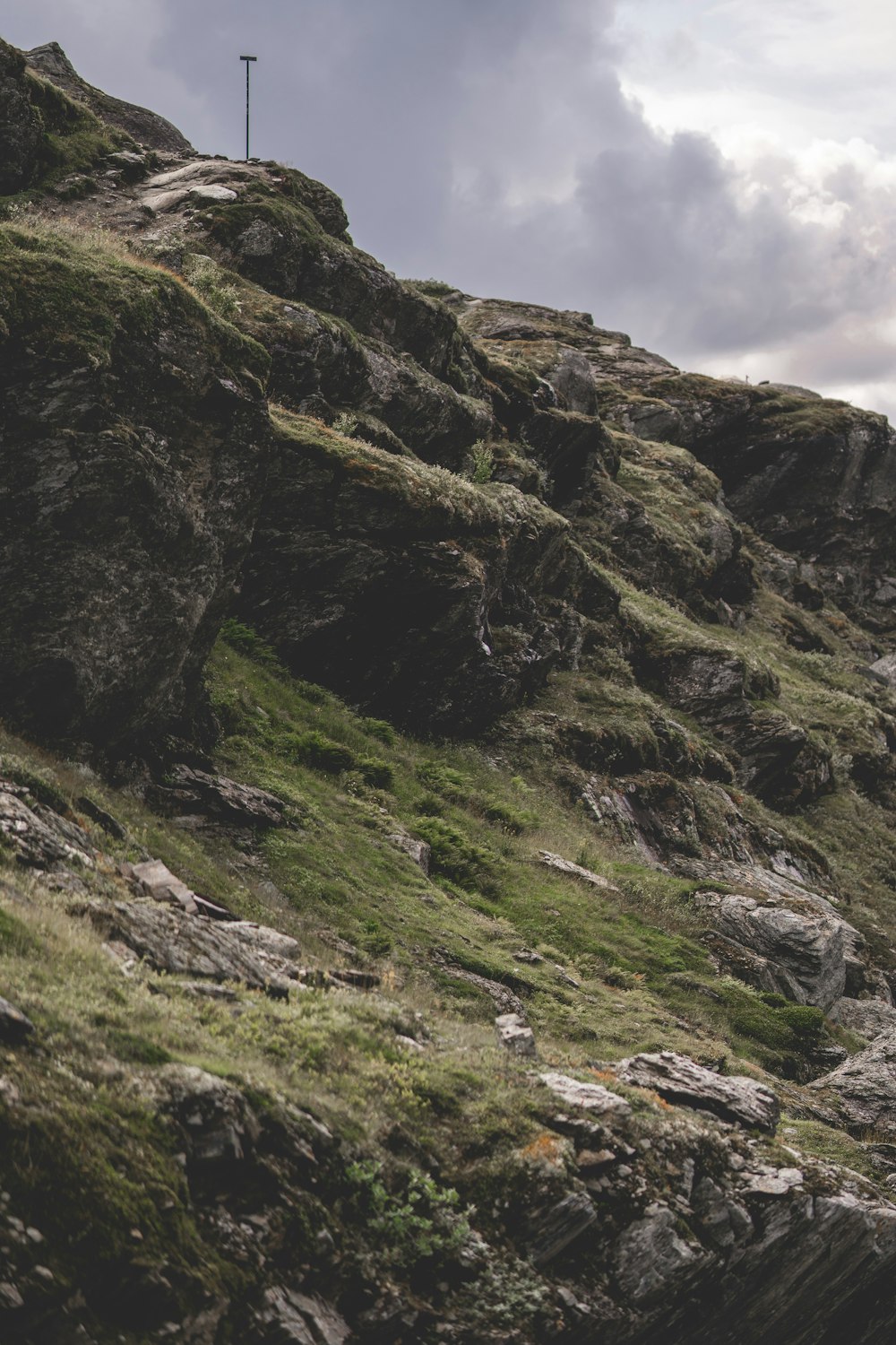 a cross on top of a rocky hill