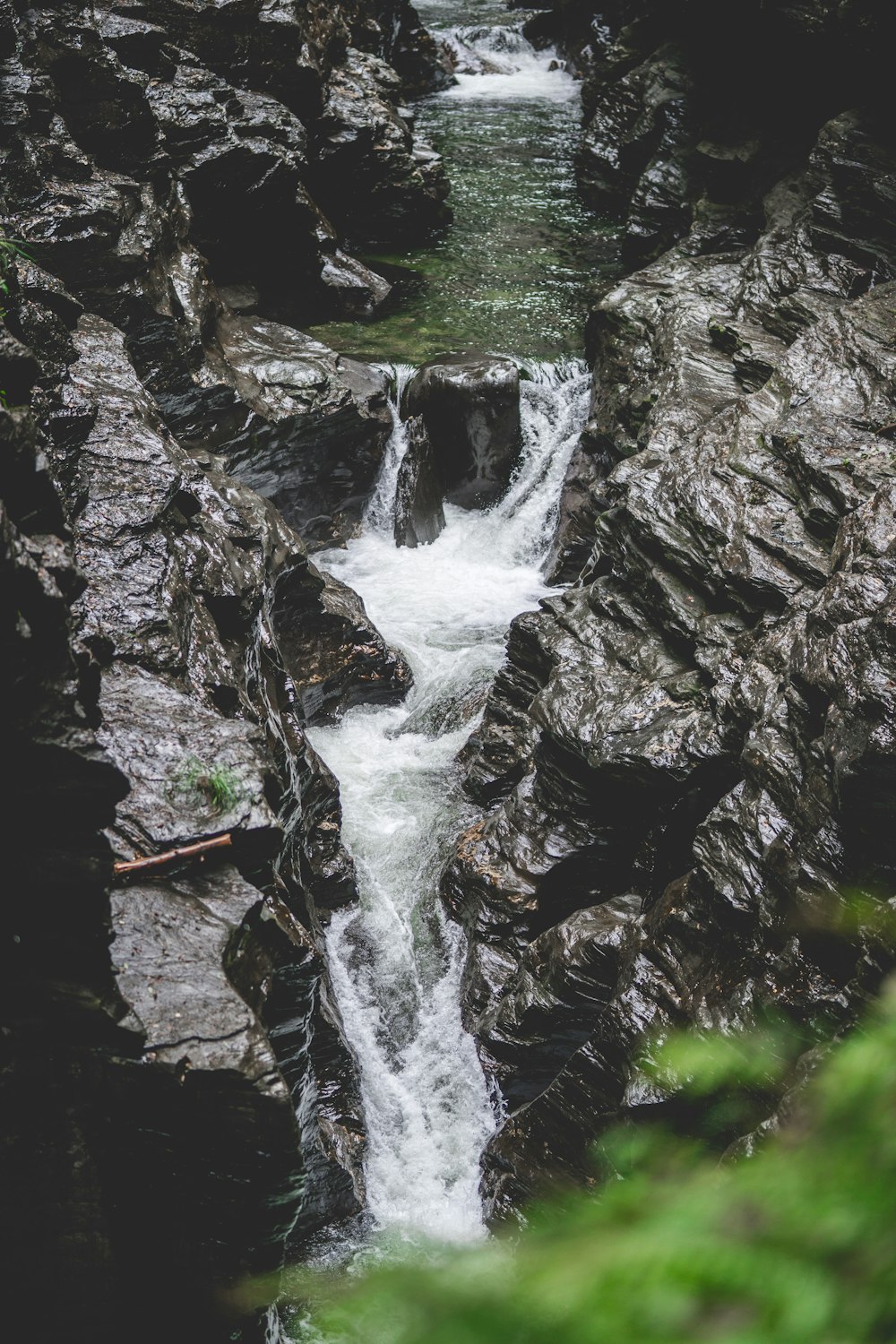 a small waterfall flowing down a rocky hillside