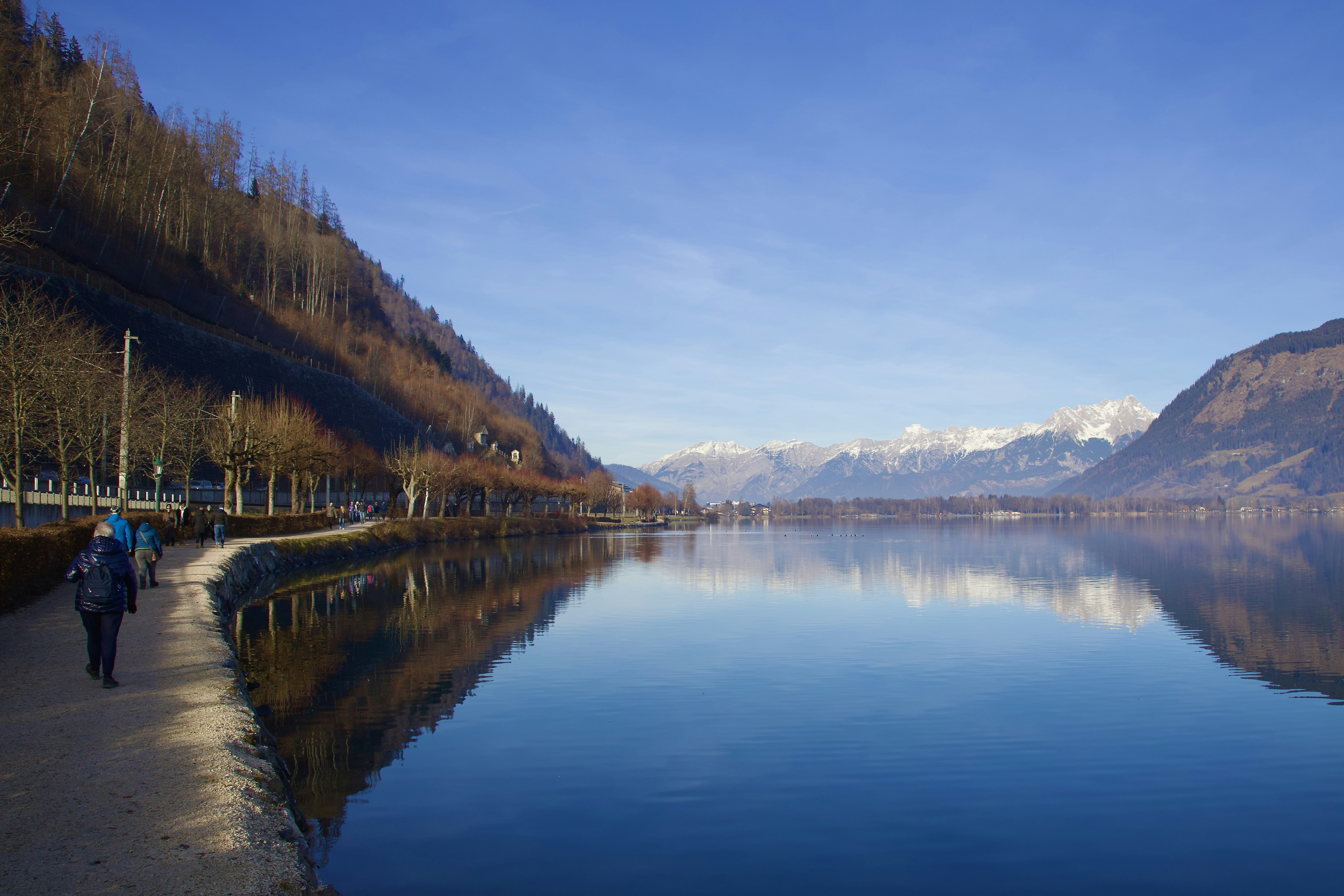 a person walking on a path next to a body of water