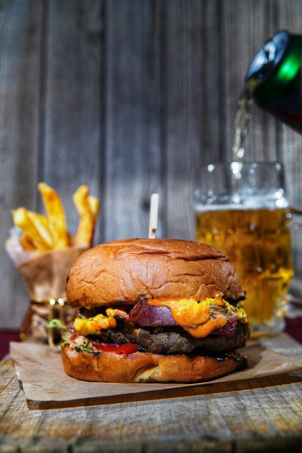 a large hamburger sitting on top of a wooden cutting board