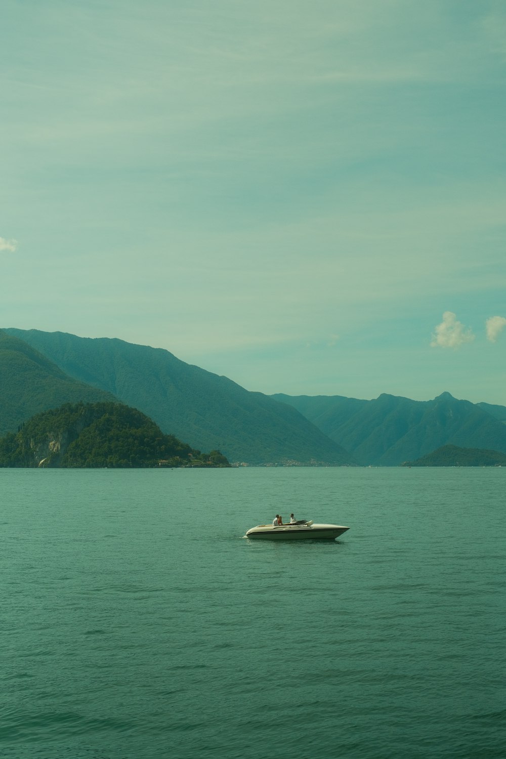 a small boat in the middle of a large body of water