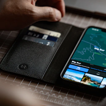 a person holding a cell phone in their hand