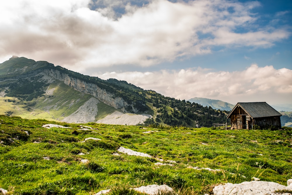 a house on a hill with a mountain in the background