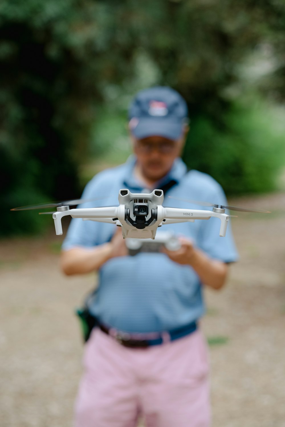 a man holding a small white and black remote control plane