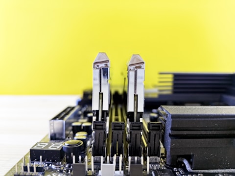 Close-up of hands installing new RAM sticks into a desktop computer.
