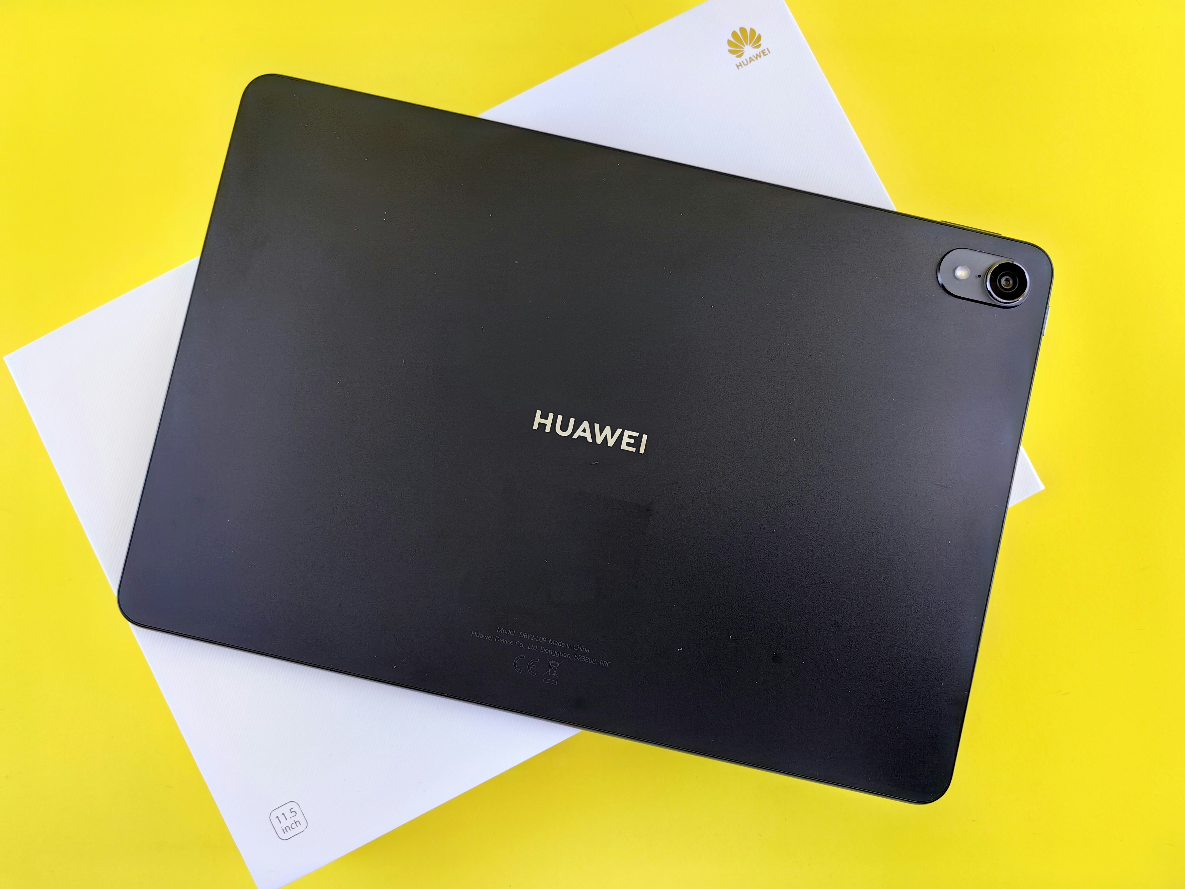 a black tablet sitting on top of a yellow table