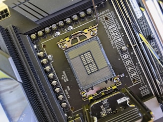 A close-up view of a computer motherboard highlighting the CPU socket area. The metallic CPU bracket is visible, surrounded by capacitors and various circuit components. The brand 'Gigabyte' and model 'Z790 AORUS MASTER' are printed along with specifications for memory slots. The detailed etchings and intricate circuitry are prominent.