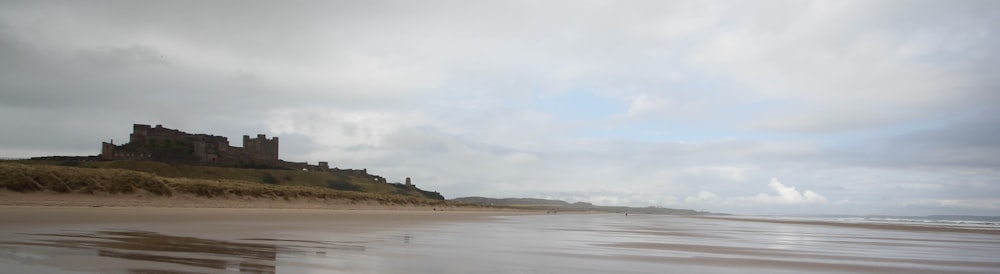 a beach with a castle in the background