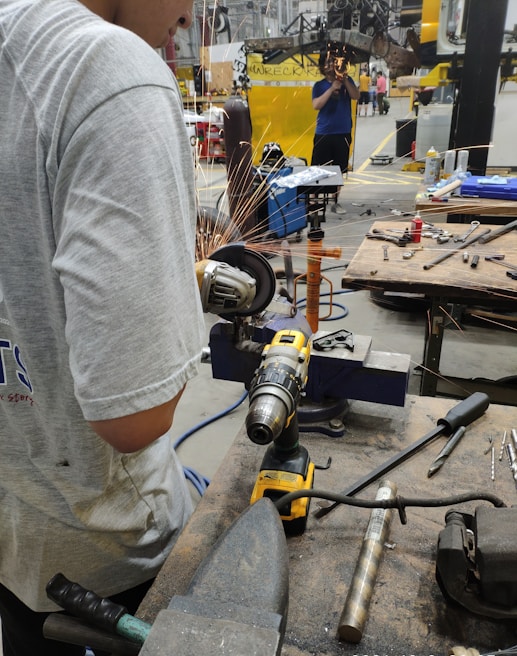 An industrial scene showcasing workers using fastening tools.