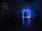 Man in a modern gallery space observing a digital art installation with neon lights