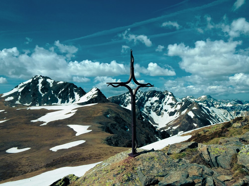 a cross on top of a mountain in the mountains
