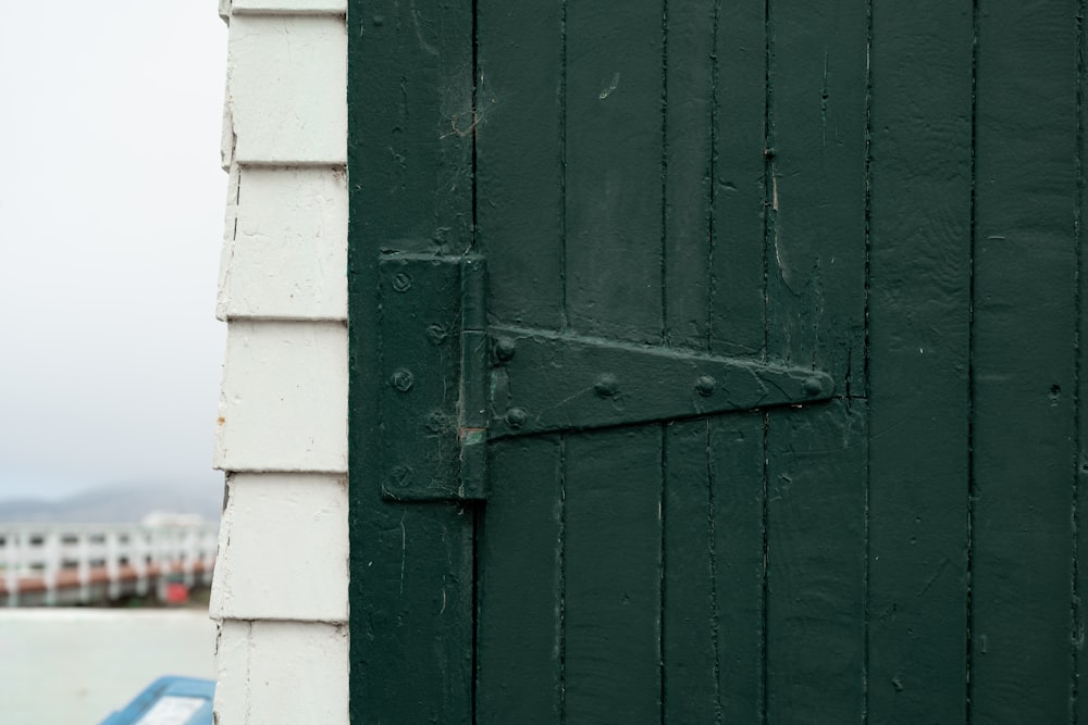 a close up of a green door on a building