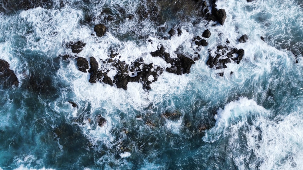 a bird's eye view of the ocean and rocks