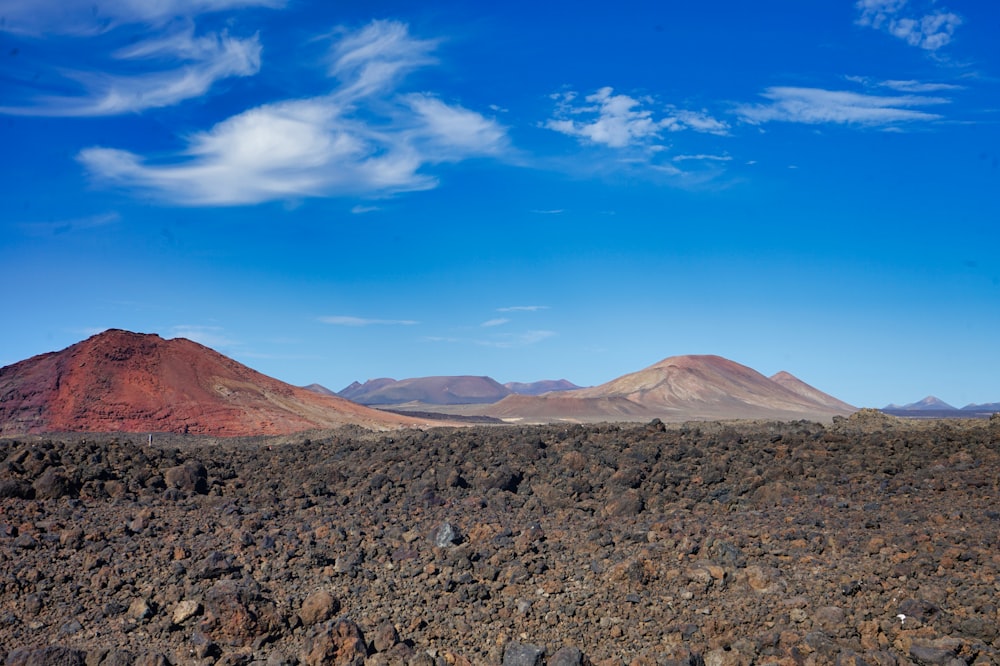 a mountain range in the desert under a blue sky