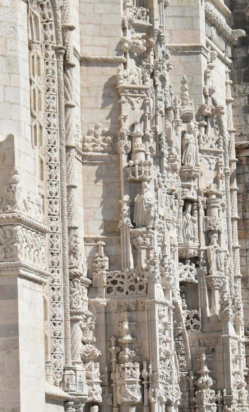 a very tall building with statues on the side of it