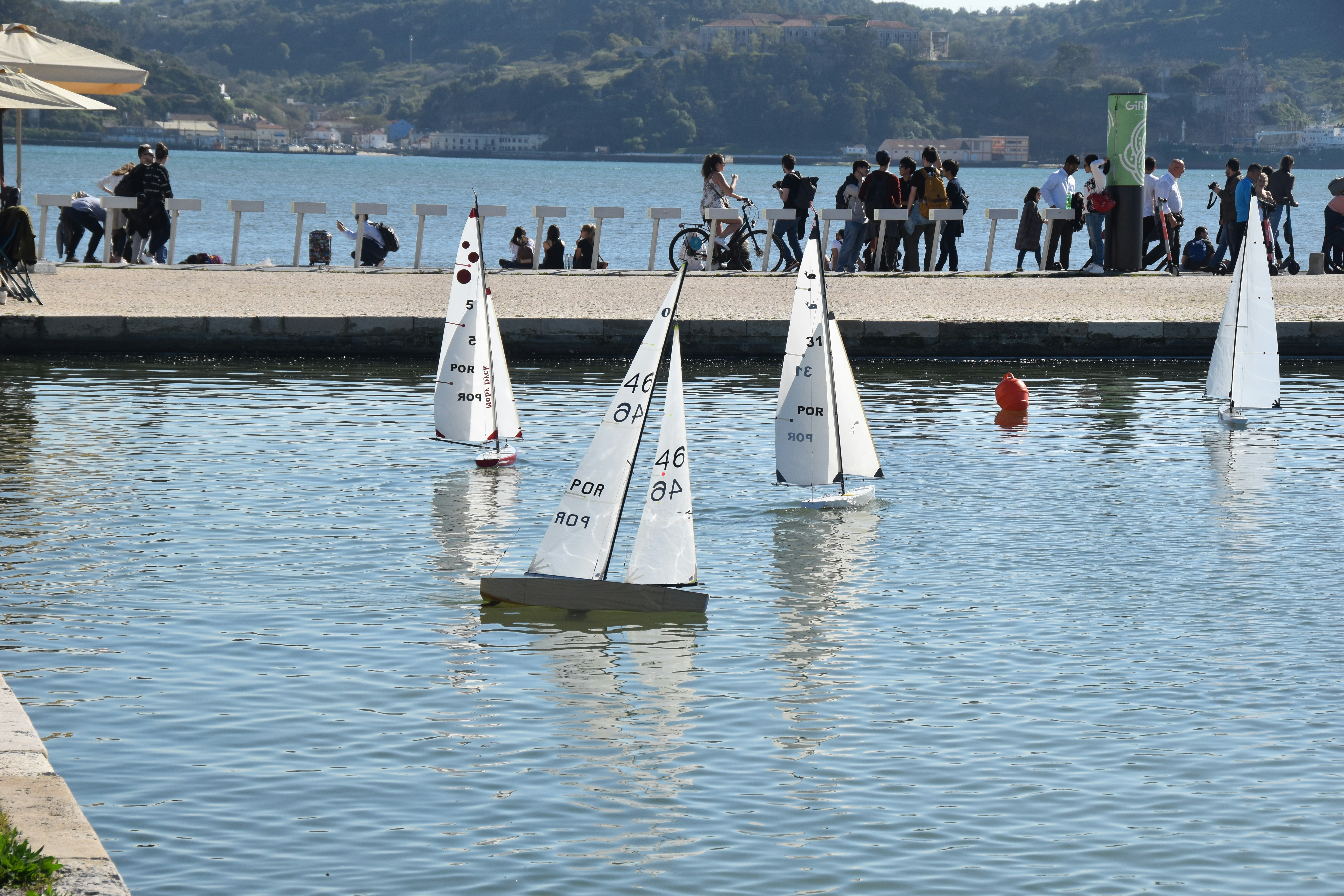 a group of sailboats floating on top of a lake