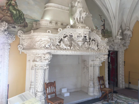 Elegant marble fireplace surrounded by cozy armchairs.