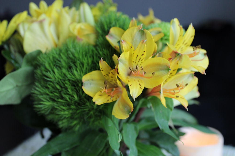 a bouquet of yellow flowers sitting on top of a table