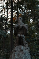 An artistic representation of a mythical creature in a dark forest.