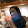 Portrait of a smiling woman in a cozy office setting.