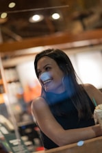 A friendly travel agent assisting a client with a smile in a cozy office.