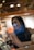 A smiling woman reviewing financial documents in a cozy office setting.