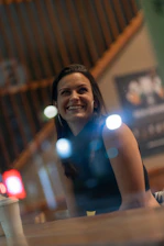 A small business owner smiling while discussing compliance paperwork.