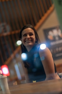 A smiling person sharing their positive experience at a cozy venue.